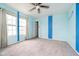 The airy bedroom is filled with sunlight from the expansive windows and light blue accent at 2885 Holiday Way, Greenwood, IN 46143