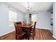 Bright dining room features a wooden table set, chandelier, and door to the outside at 2885 Holiday Way, Greenwood, IN 46143