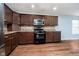 Well-lit kitchen featuring brown cabinets, stainless steel appliances, and tile backsplash at 2885 Holiday Way, Greenwood, IN 46143