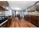 Open kitchen and dining area with wood floors, blue walls, and plentiful natural light at 2885 Holiday Way, Greenwood, IN 46143