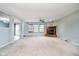 Open-concept living area featuring a brick fireplace, ceiling fan, and views of adjacent rooms creating a seamless flow at 2885 Holiday Way, Greenwood, IN 46143