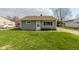 Cozy single-story home with gray siding and a well-manicured lawn and a paved drive at 380 Parkway St, Whiteland, IN 46184