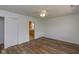 Bright living room featuring laminate flooring and a ceiling fan, with kitchen view at 380 Parkway St, Whiteland, IN 46184