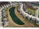 A lovely aerial view shows a pond-front property nestled in a charming residential neighborhood at 4148 Basswood Dr, Danville, IN 46122