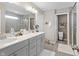 A modern bathroom boasts double sinks, gray cabinets, and a large mirror at 4148 Basswood Dr, Danville, IN 46122