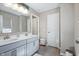 Bright bathroom featuring double sinks, gray cabinets, and ample countertop space at 4148 Basswood Dr, Danville, IN 46122