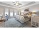Spacious bedroom featuring a king bed, tray ceiling, and an area rug at 4148 Basswood Dr, Danville, IN 46122