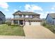 Inviting two-story home featuring a three-car garage and manicured front lawn at 4148 Basswood Dr, Danville, IN 46122