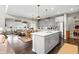 Modern kitchen with an island and stainless steel appliances, seamlessly connected to the dining and living areas at 4148 Basswood Dr, Danville, IN 46122