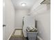 Well-lit laundry room featuring a front-load washer, overhead shelving, and a neutral color scheme at 4148 Basswood Dr, Danville, IN 46122