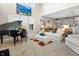 Bright living room features a soaring ceiling, large windows, piano, and seamlessly connects to the kitchen at 4148 Basswood Dr, Danville, IN 46122