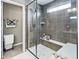 Modern shower with sleek tilework, a built-in bench, and a glass enclosure at 4148 Basswood Dr, Danville, IN 46122