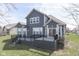 Backyard showcasing a gray two-story house with a deck and a well-maintained lawn at 4182 Backstretch Ln, Bargersville, IN 46106
