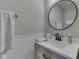 Bathroom with a gray color scheme, framed mirror, and wainscoting detail at 4182 Backstretch Ln, Bargersville, IN 46106