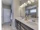 Bathroom with a double sink vanity and a large mirror reflecting the shower at 4182 Backstretch Ln, Bargersville, IN 46106