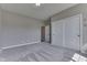 Bedroom with neutral walls and flooring, a door to a bathroom, and closet at 4182 Backstretch Ln, Bargersville, IN 46106
