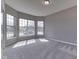 Sunlit bedroom with large windows, carpet flooring, and neutral wall color at 4182 Backstretch Ln, Bargersville, IN 46106