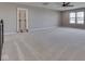 Spacious bonus room with plush carpeting, neutral paint, a ceiling fan, and bright natural light at 4182 Backstretch Ln, Bargersville, IN 46106