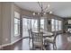 Dining area featuring a modern chandelier, large windows, and view to outdoor deck at 4182 Backstretch Ln, Bargersville, IN 46106