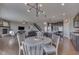 Open-concept dining area showcasing a modern chandelier and connection to the kitchen at 4182 Backstretch Ln, Bargersville, IN 46106