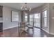 Bright dining area featuring a modern chandelier, sliding glass doors, and hardwood floors at 4182 Backstretch Ln, Bargersville, IN 46106