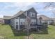 View of gray siding and deck of home with green lawn, steps, and railings at 4182 Backstretch Ln, Bargersville, IN 46106