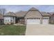 Attractive brick home with a three car garage and well-maintained lawn at 4182 Backstretch Ln, Bargersville, IN 46106