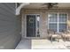 Charming front porch with brick accents, a wreath, and stylish seating area at 4182 Backstretch Ln, Bargersville, IN 46106