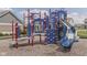 Community playground with a blue slide and other features built on a mulch bed for safety at 4182 Backstretch Ln, Bargersville, IN 46106