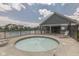 Community pool area features a fenced-in hot tub, lounging chairs, and a covered pavilion with seating at 4182 Backstretch Ln, Bargersville, IN 46106