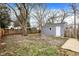 Spacious fenced-in backyard with grass and detached garage with white door at 5309 E 19Th Pl, Indianapolis, IN 46218