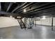 Spacious basement with painted floors and ceiling, utility components and metal stairs at 5309 E 19Th Pl, Indianapolis, IN 46218