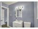 Cozy bathroom featuring a stylish vanity, well-lit mirror, and a conveniently located toilet at 5309 E 19Th Pl, Indianapolis, IN 46218