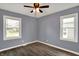 Inviting bedroom featuring a ceiling fan and two windows, offering ample natural light and ventilation at 5309 E 19Th Pl, Indianapolis, IN 46218