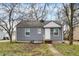 Charming single-story home featuring gray siding, white trim, and a well-maintained front lawn and a classic design at 5309 E 19Th Pl, Indianapolis, IN 46218
