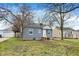 Single-story house with gray siding and a neat front yard, offering a cozy curb appeal and a detached garage at 5309 E 19Th Pl, Indianapolis, IN 46218