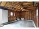 Unfinished garage with exposed wood framing, concrete floor and white door at 5309 E 19Th Pl, Indianapolis, IN 46218