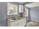 Well-lit kitchen with stainless steel sink, white cabinets, and lots of natural light from two windows at 5309 E 19Th Pl, Indianapolis, IN 46218