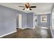 Inviting living room features modern gray walls, wood flooring, white trim and a ceiling fan for added comfort at 5309 E 19Th Pl, Indianapolis, IN 46218