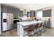 Modern kitchen boasts stainless steel appliances, a large island with seating, and stylish gray cabinetry at 540 Galveston Ln, Westfield, IN 46074