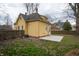 Backyard view featuring a yellow house with a new concrete patio at 5915 Lowell Ave, Indianapolis, IN 46219