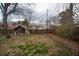 Leafy backyard featuring a rustic shed and ample space, ready for gardening or outdoor enjoyment at 5915 Lowell Ave, Indianapolis, IN 46219