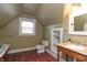 Well-lit bathroom with a classic clawfoot tub, vanity, and tiled floor at 5915 Lowell Ave, Indianapolis, IN 46219