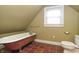 Bathroom featuring a vintage clawfoot tub, tiled floors, and natural light at 5915 Lowell Ave, Indianapolis, IN 46219