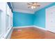 Inviting bedroom with blue walls, hardwood floors, and large windows, creating a peaceful atmosphere at 5915 Lowell Ave, Indianapolis, IN 46219