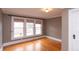 Bedroom featuring neutral walls, hardwood floors, white trim, and a window with natural light, creating a cozy atmosphere at 5915 Lowell Ave, Indianapolis, IN 46219