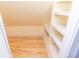 Walk-in closet with custom shelving and hardwood flooring for optimal storage at 5915 Lowell Ave, Indianapolis, IN 46219