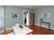 Dining room features hardwood floors, light green walls, and doorway to a kitchen at 5915 Lowell Ave, Indianapolis, IN 46219