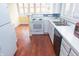 Kitchen featuring modern appliances, white cabinets and hardware, and a double stainless steel sink at 5915 Lowell Ave, Indianapolis, IN 46219