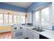 Bright kitchen featuring modern appliances, white cabinets and hardware, and a double stainless steel sink at 5915 Lowell Ave, Indianapolis, IN 46219